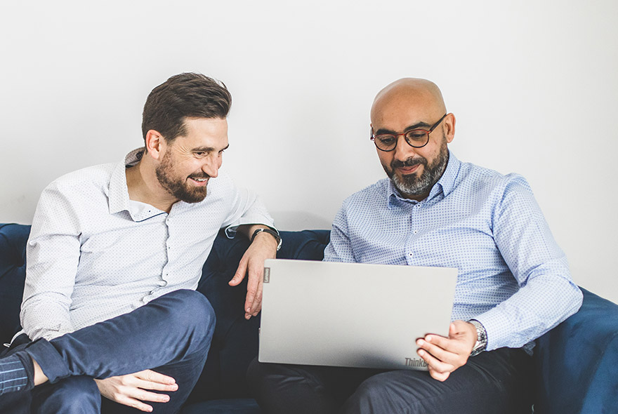 Badre and Arnaud, Ipanova founders and former SAP consultants, working at a laptop